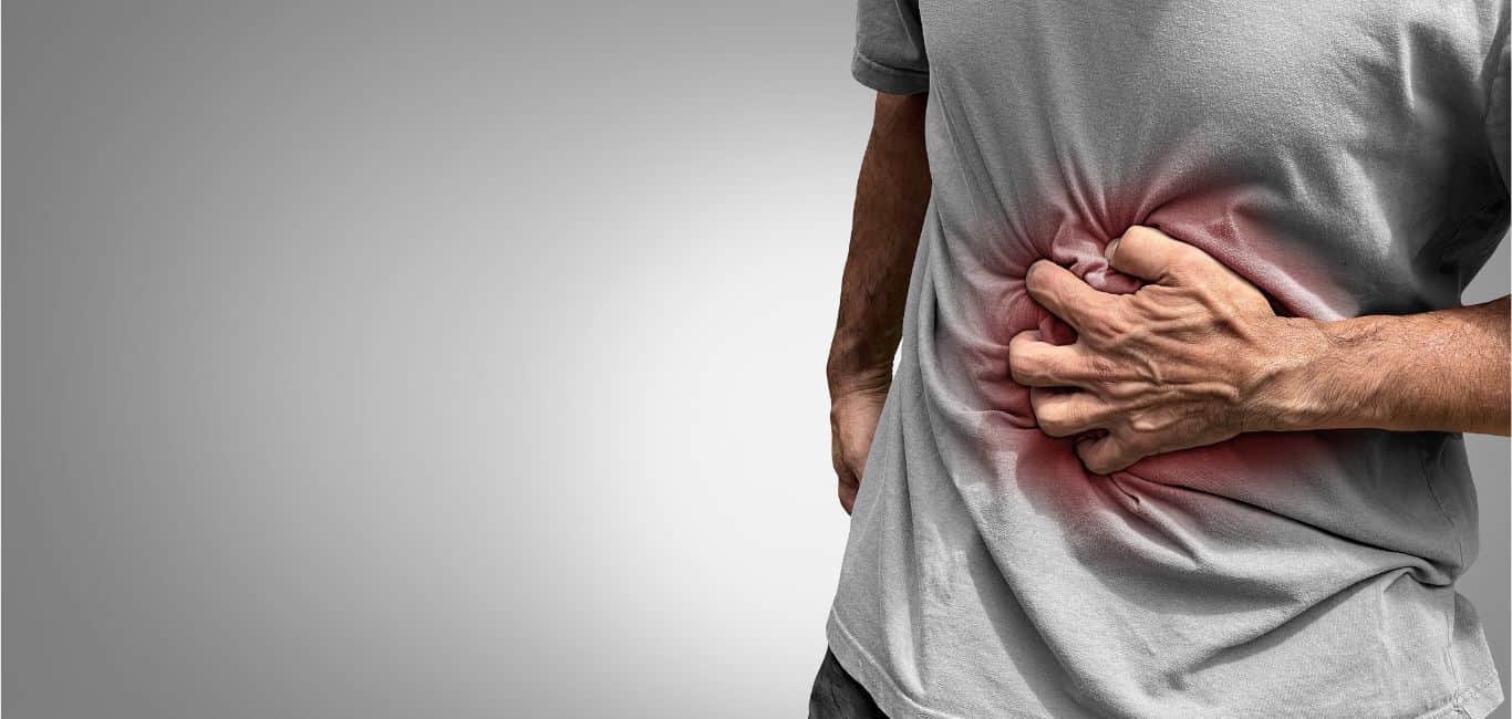 Image of a person holding his stomach due to chronic gut pain