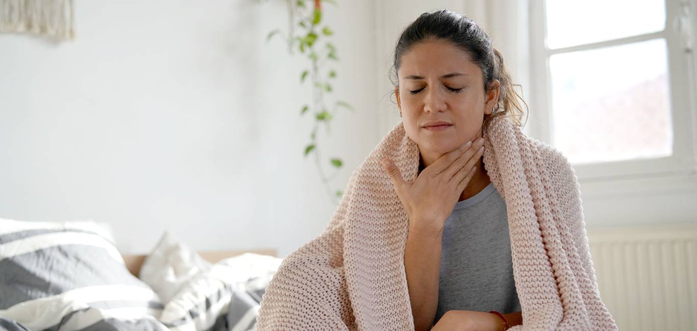 A woman suffering from sore throat