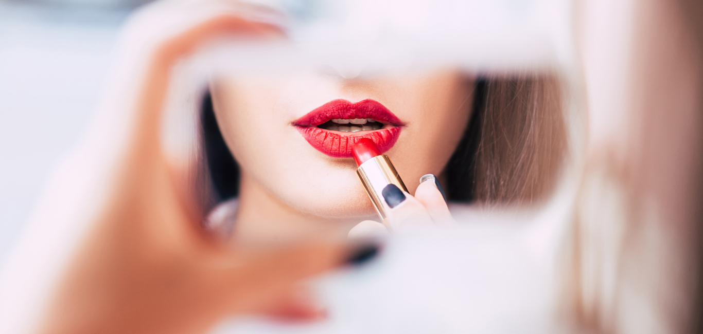 are lipsticks harmful? Woman applying red lipstick