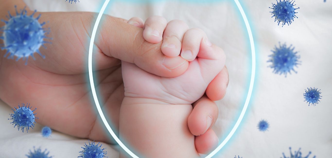 A photograph of a baby's palm with a shield fighting off viruses illustrated