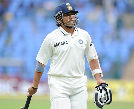 In September 2012, the Indian cricketer Sachin Tendulkar is seen walks back to the pavilion during the Test against New Zealand in Bengaluru, wearing a tennis elbow band on his right arm.